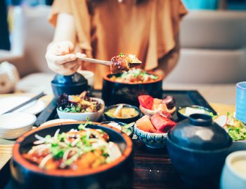 food in front of young woman at restaurant