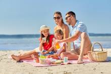 A family enjoying a beach picnic near the water
