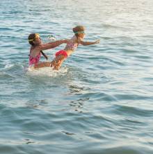 Two kids playing in the water.