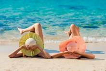 Two women lounging on the beach