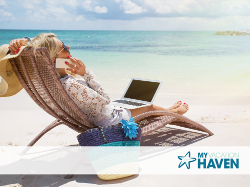 Woman on Laptop Working Near Beach